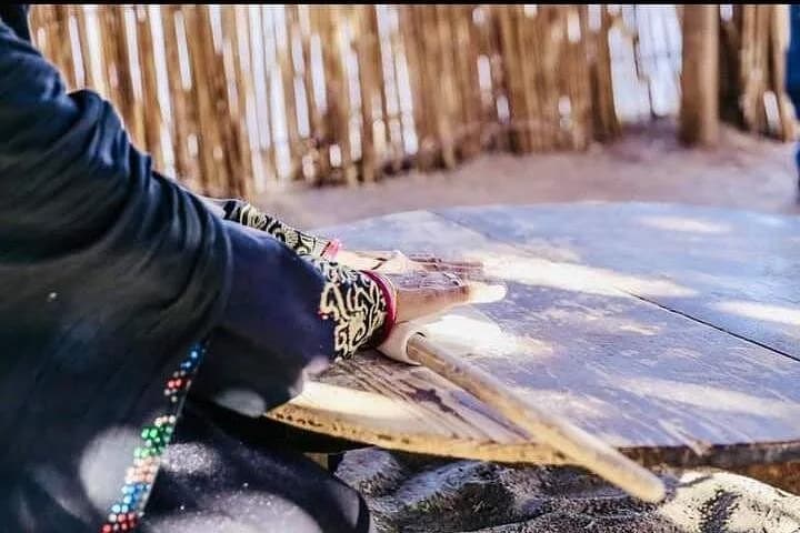 Close-up of hand kneading dough for traditional Bedouin bread