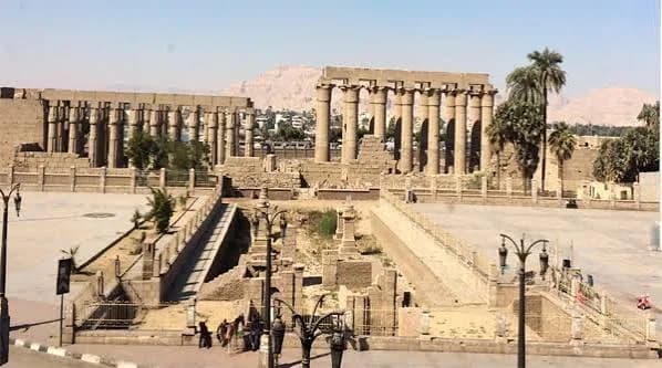 Die Kolonnade des Luxor-Tempels mit antiken Säulen und Statuen, beleuchtet von der Nachmittagssonne