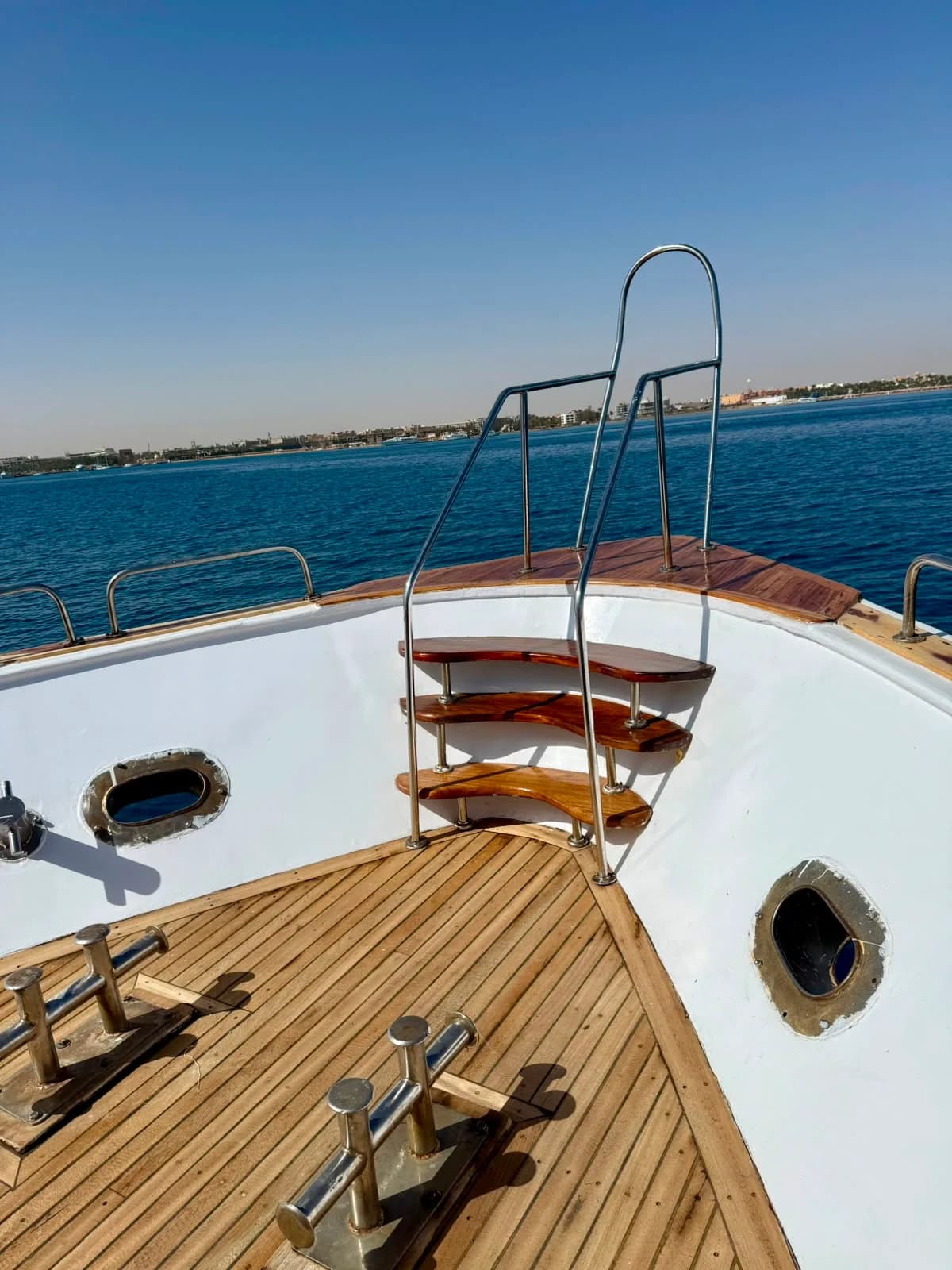 Guests relaxing on the bow deck of the VIP sunset cruise yacht