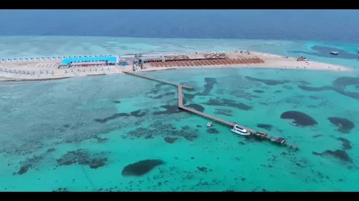 Aerial view of Bianca Island Utopia's beach, jetty and turquoise reef waters