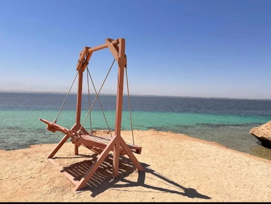 Overwater swing at Magawish Island, a stop on the VIP sunset cruise